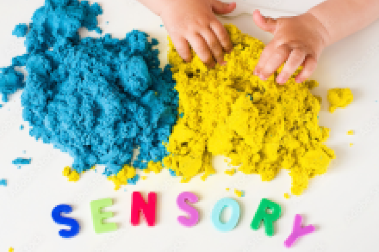 Toddlers hands playing with magic sand