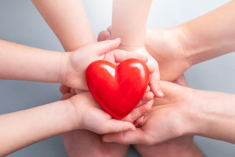 hands holding a red heart