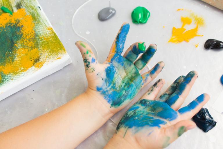 Child hands doing hand painting